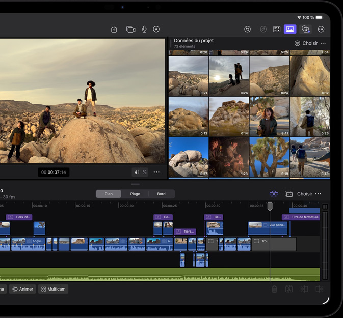 Un iPad Pro, face avant, orientation paysage, noir infini, écran affichant l’interface de Final Cut Pro, un projet ouvert montre une aventure dans le désert, photo de quatre personnes dans un paysage désertique, nombreux clips vidéo et timeline