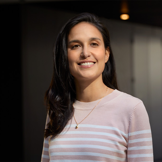 Camila a sorrir no interior de um escritório.