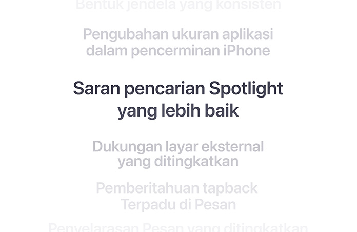 Daftar fitur secara vertikal, dengan “Saran pencarian Spotlight yang lebih baik” ditampilkan tebal di tengah. Fitur-fitur sekitarnya memudar menjadi latar belakang di atas dan di bawah.