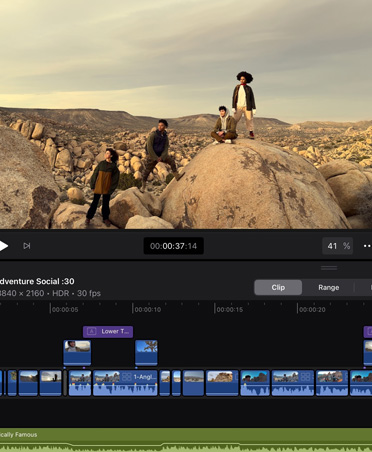 Video editing app with image of people posing on boulders in a rocky desert landscape, timeline, editing tools