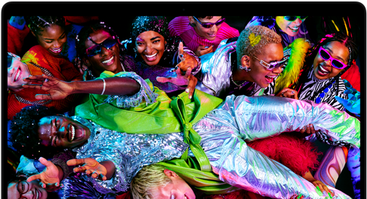 Colorful screen on a MacBook Pro of a person crowd-surfing at a party, showcasing the vibrant Liquid Retina XDR display
