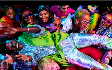 Colorful screen on a MacBook Pro of a person crowd-surfing at a party, showcasing the vibrant Liquid Retina XDR display