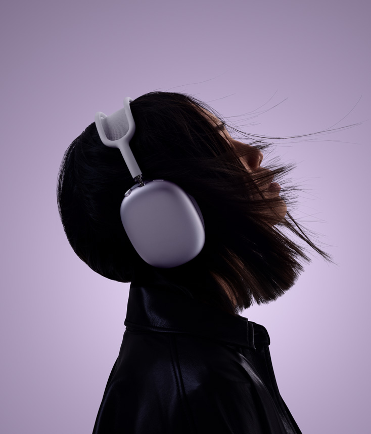 Profile of person wearing AirPods Max 2 headphones in purple colour with head tilted up slightly