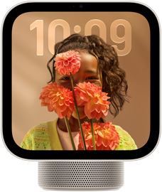 Apple HomeView, starlight color (pale gold), screen shows semi-transparent time of day over a wallpaper of a person holding flowers