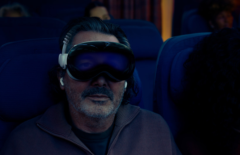 Person seated on an aeroplane wearing Apple Vision Pro assembled with Dual Knitted Band