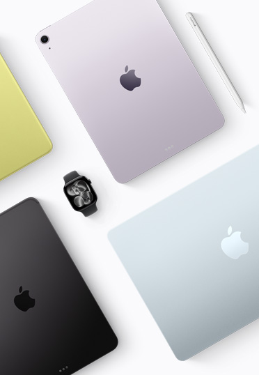 A top-down view of different coloured Mac and iPad devices, with a black Apple Watch in the centre.