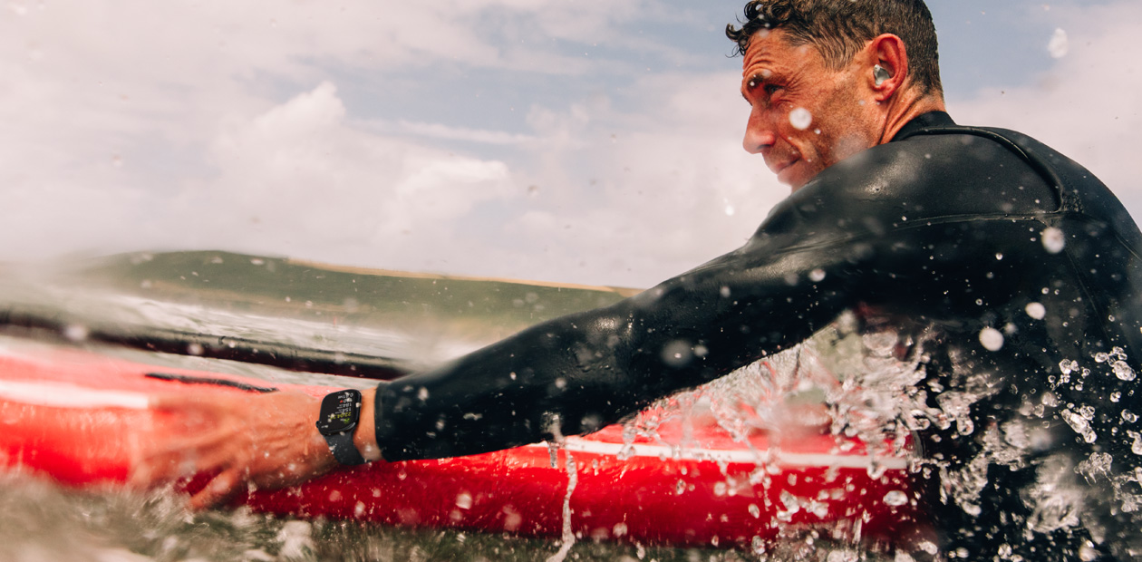 A man surfing with Apple Watch.