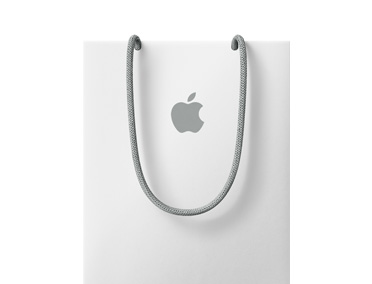 Un sac Apple Store, blanc, avec logo Apple gris et poignées grises