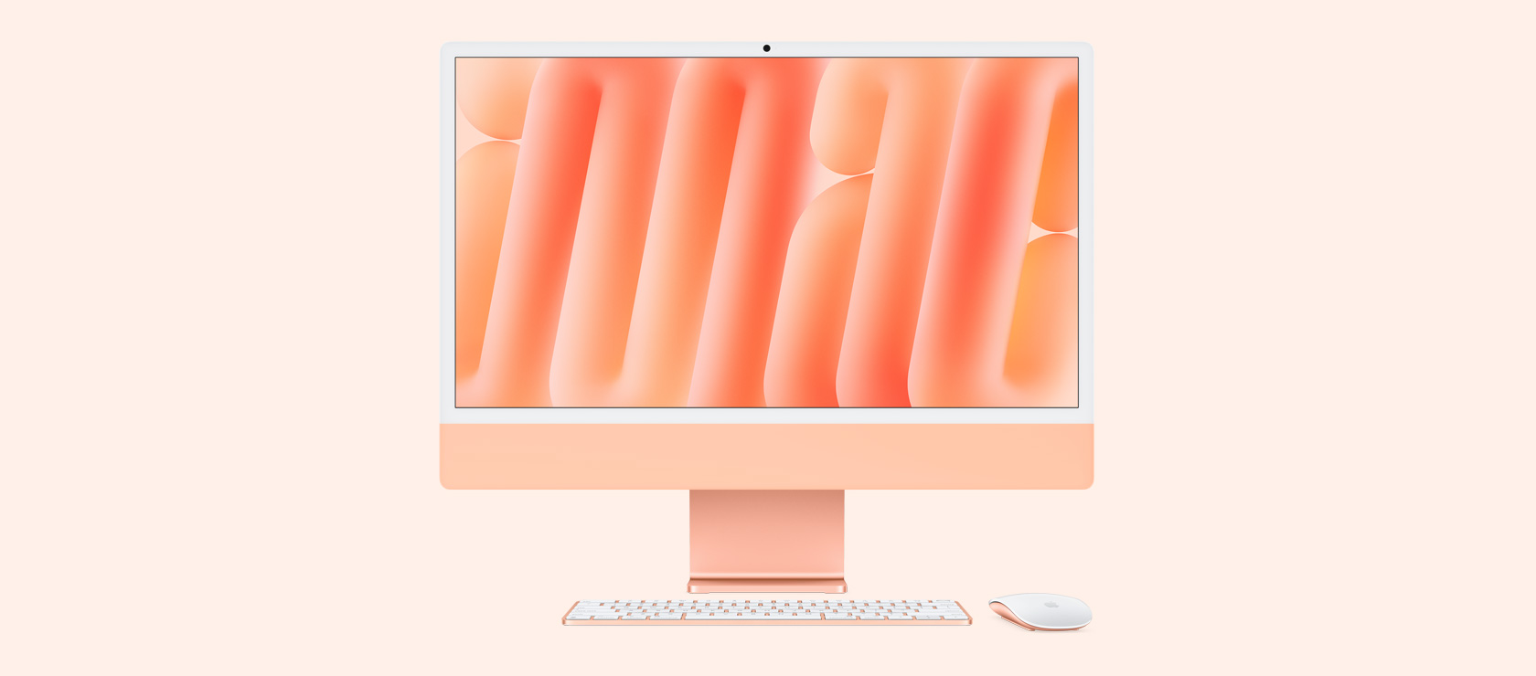 Oranž iMac eestvaates koos sama värvi hiire ja klaviatuuriga