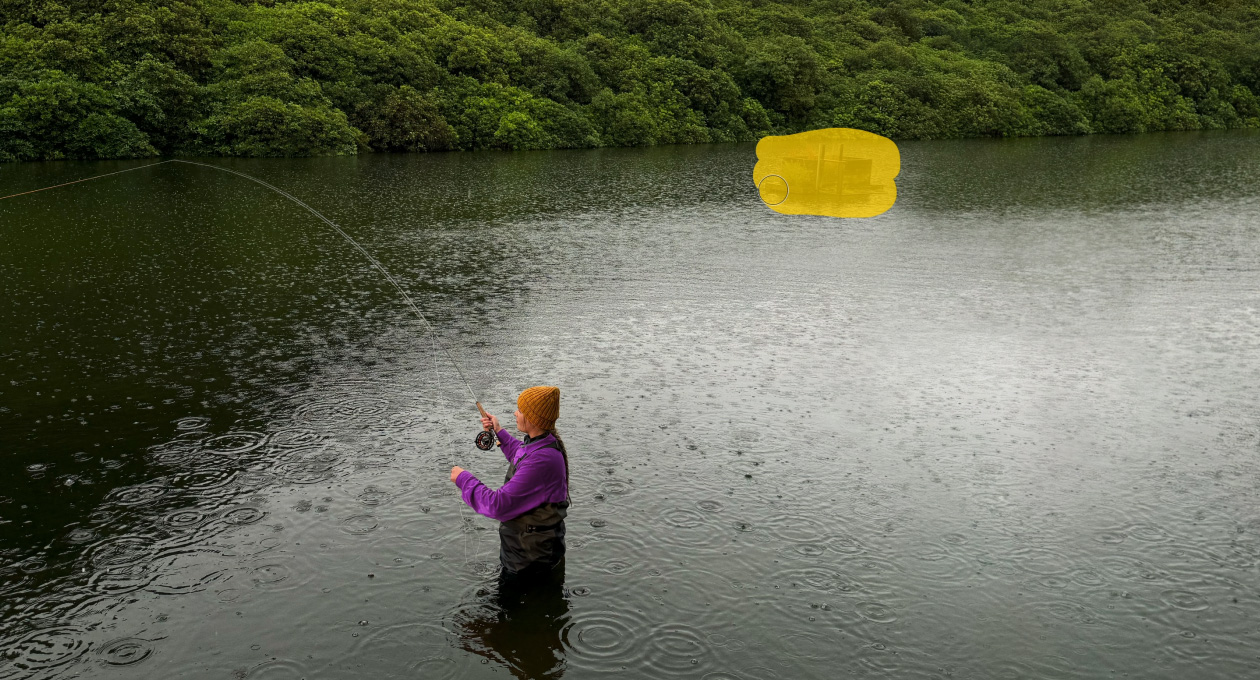 Photo of a woman fly-fishing on a lake, Pixelmator Pro tool removing unwanted object in the background being highlighted in yellow