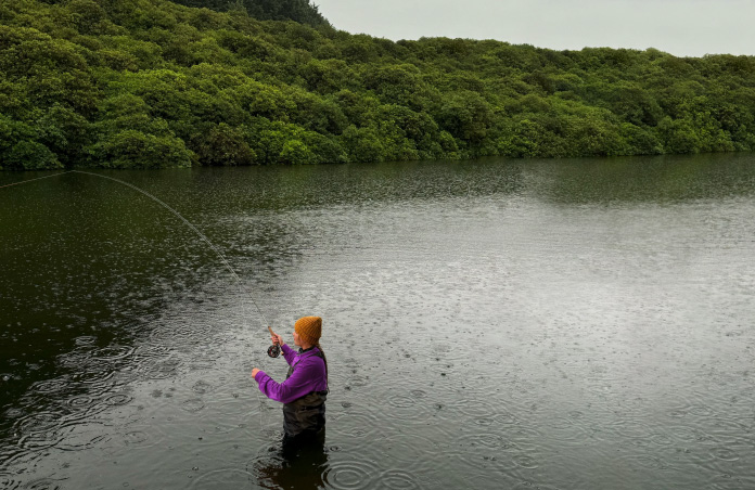 Photo of woman fly-fishing on lake, Pixelmator Pro tool removing unwanted objects